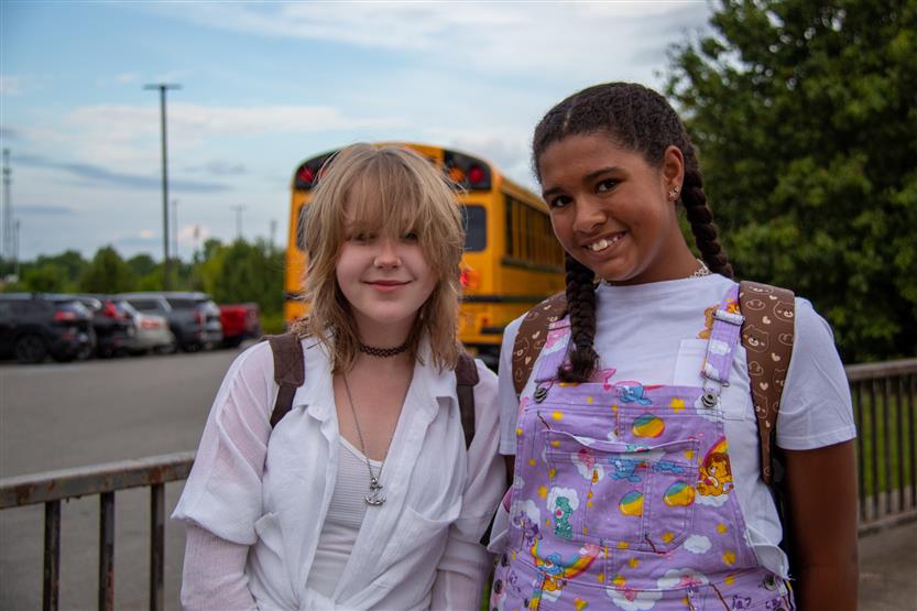 Two students smile